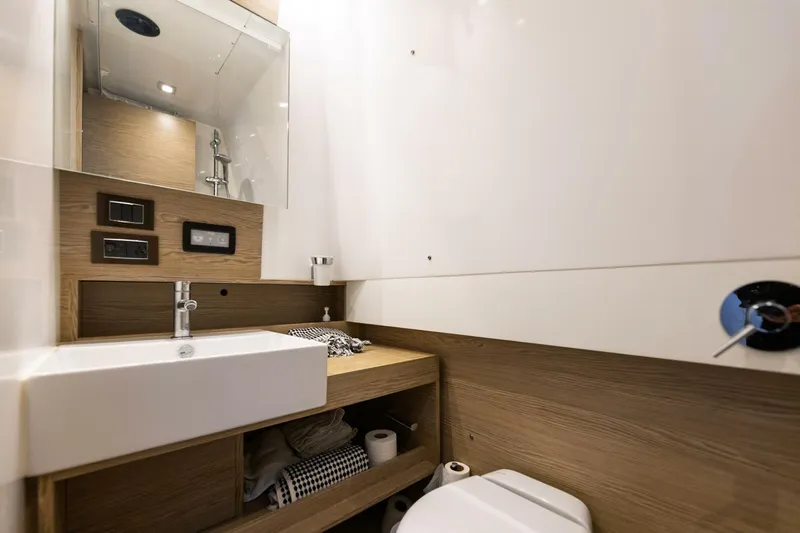 Loki Yacht Photos Pics Modern bathroom interior on 2018 Azimut Verve 40 yacht, featuring sleek sink and wooden accents.
