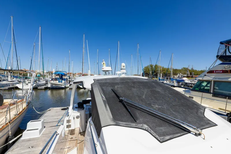 Loki Yacht Photos Pics 2018 Azimut Verve 40 yacht docked in a marina under clear blue skies.