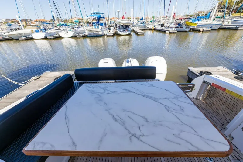 Loki Yacht Photos Pics 2018 Azimut Verve 40 yacht with marble table, docked at marina.