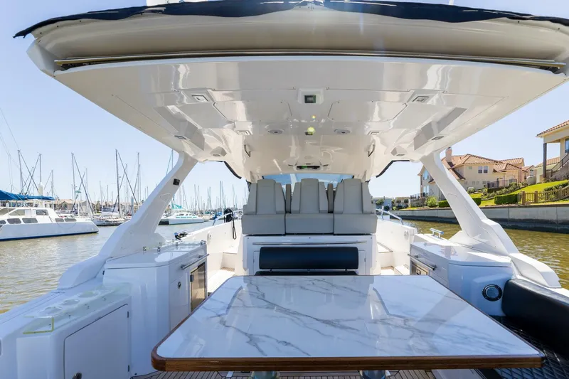 Loki Yacht Photos Pics 2018 Azimut Verve 40 yacht interior with marble table, docked at marina.