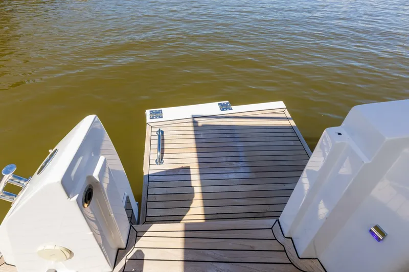 Loki Yacht Photos Pics 2018 Azimut Verve 40 yacht's teak swim platform on calm water.