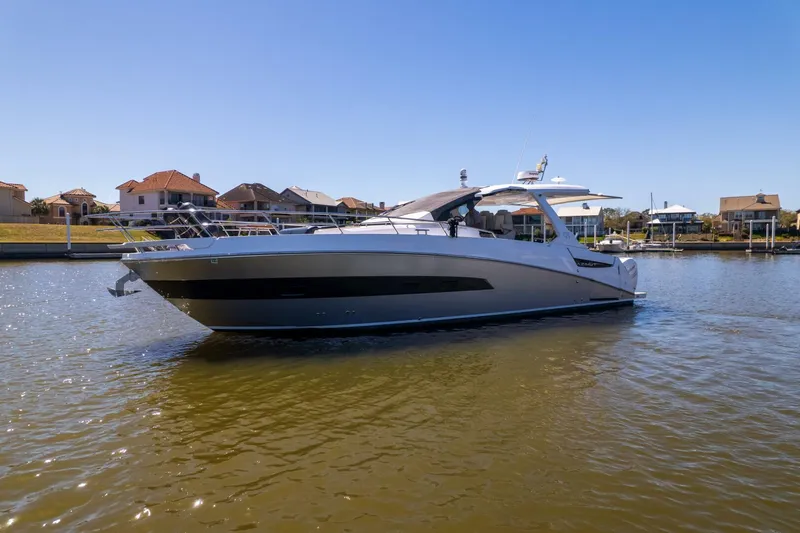 Loki Yacht Photos Pics 2018 Azimut Verve 40 yacht cruising on a sunny day in a residential marina.