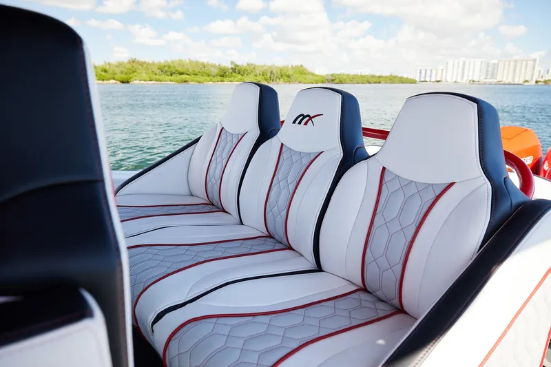 Yacht Photos Pics Luxurious seating on 2025 Midnight Express 37' Open boat, featuring stylish white and red upholstery.