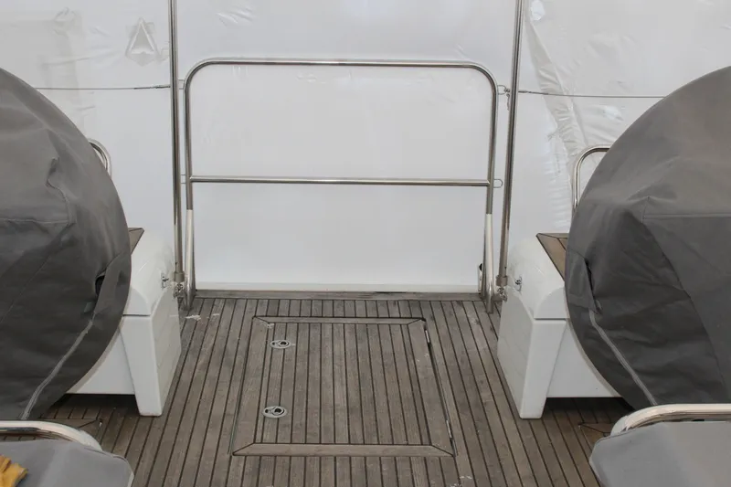 Spellbound Yacht Photos Pics Looking aft: Easy access to the fold-down transom, tender garage etc. Beneteau Oceanis Yacht 54 cockpit, 2022 model, featuring teak flooring and covered seating.