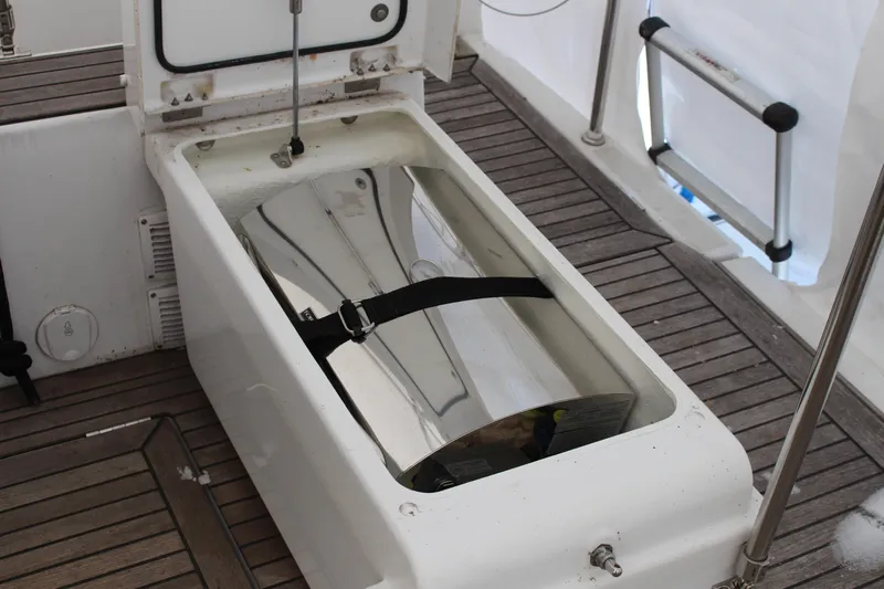 Spellbound Yacht Photos Pics Open storage compartment on 2022 Beneteau Oceanis Yacht 54 with wooden deck.