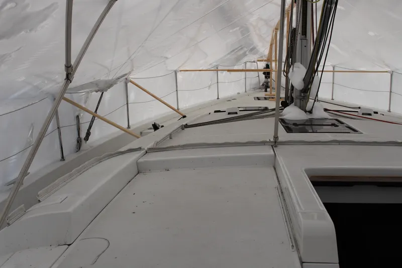 Spellbound Yacht Photos Pics looking Stbd and forward: 2022 Beneteau Oceanis Yacht 54 under protective cover, showcasing deck and rigging.
