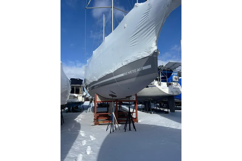 Spellbound Yacht Photos Pics 2022 Beneteau Oceanis Yacht 54 covered and stored on a snowy dock.