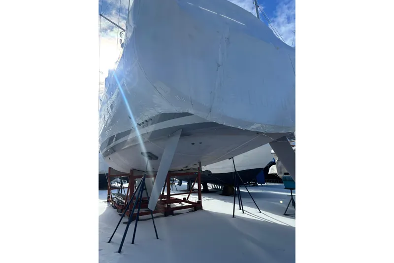 Spellbound Yacht Photos Pics Beneteau Oceanis Yacht 54 (2022) on stands, covered, under bright sky.