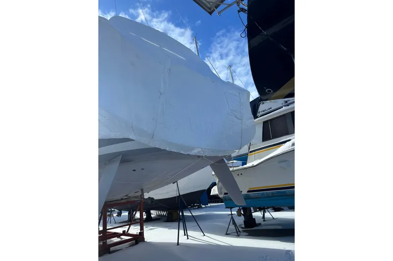Spellbound Yacht Photos Pics 2022 Beneteau Oceanis Yacht 54 covered in protective wrap, stored outdoors.