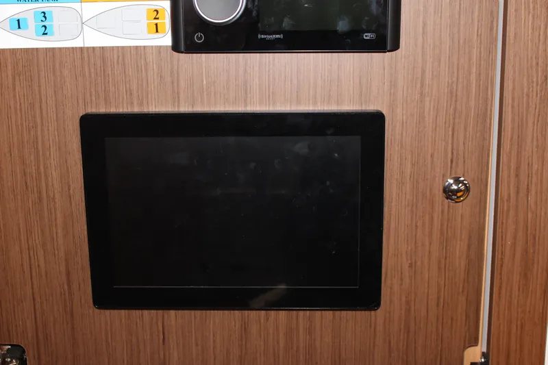 Spellbound Yacht Photos Pics Ships control panel (in colour) with networked Fusion stereo system control unit above.