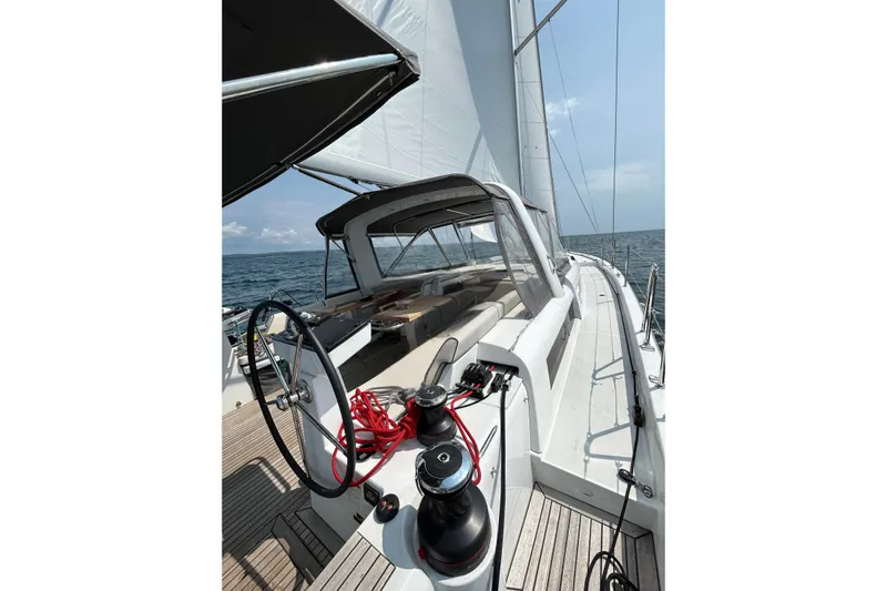Spellbound Yacht Photos Pics 2022 Beneteau Oceanis Yacht 54 sailing on open sea, showcasing deck and helm.