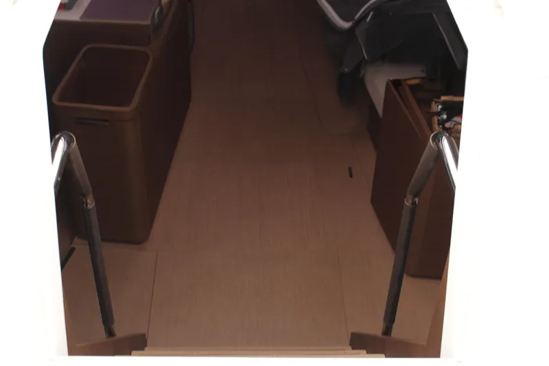 Spellbound Yacht Photos Pics Looking down and forward from the cockpit. Interior view of 2022 Beneteau Oceanis Yacht 54, featuring stairs and storage areas.