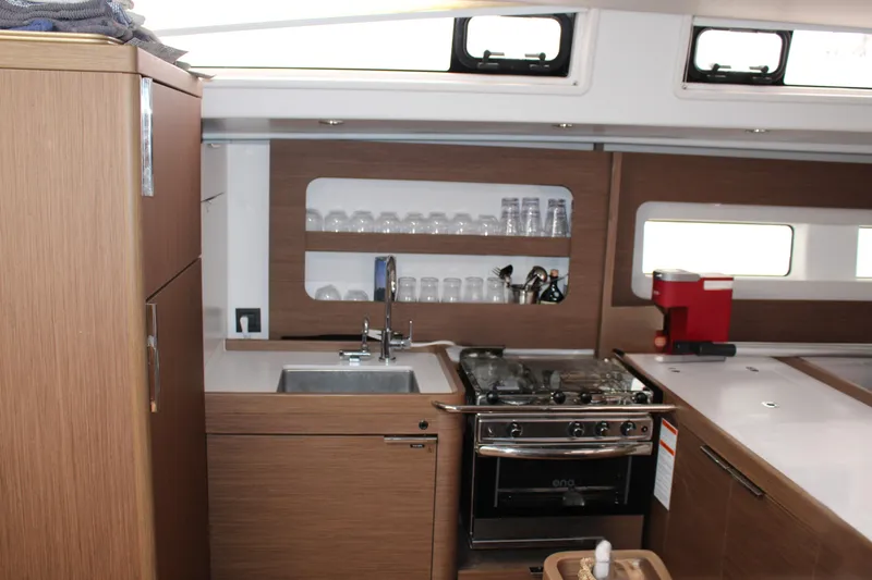Spellbound Yacht Photos Pics Modern kitchen interior of 2022 Beneteau Oceanis Yacht 54 with stove and sink.
