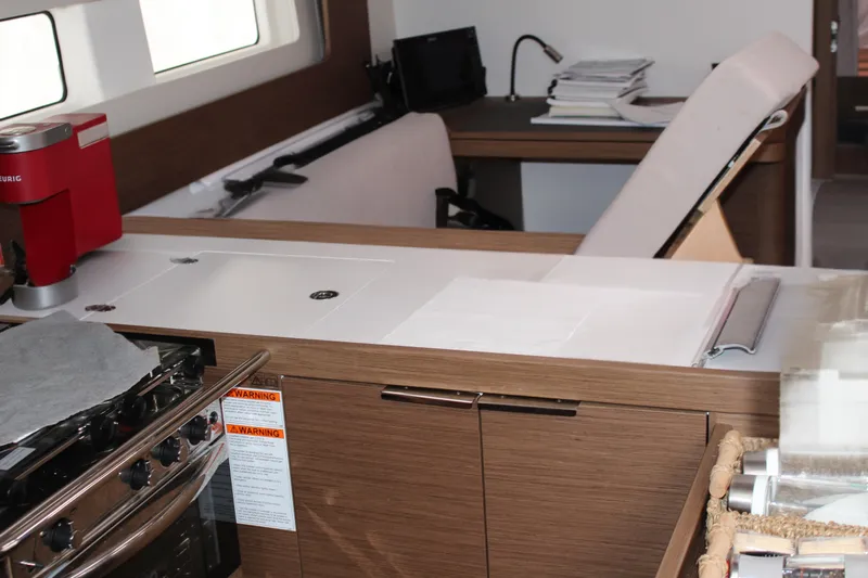 Spellbound Yacht Photos Pics Interior of 2022 Beneteau Oceanis Yacht 54 with modern kitchen and workspace.