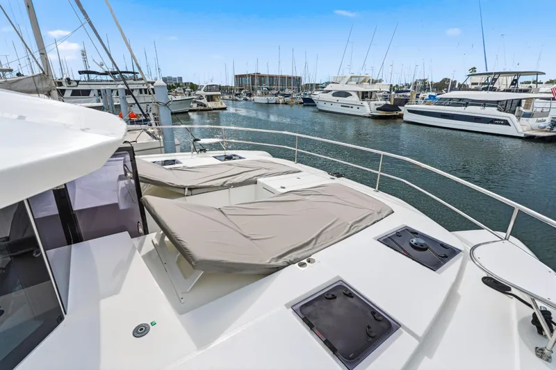 Closer To The Sun Yacht Photos Pics 2025 Leopard 53 Powercat yacht docked in a marina, surrounded by other boats.