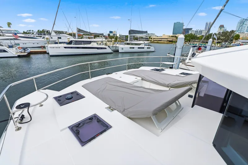 Closer To The Sun Yacht Photos Pics 2025 Leopard 53 Powercat yacht docked in marina, featuring spacious deck and modern design.