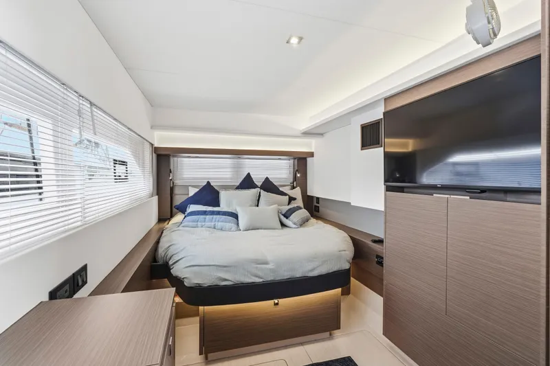 Closer To The Sun Yacht Photos Pics Luxurious bedroom interior of 2025 Leopard 53 Powercat yacht with modern design and large TV.