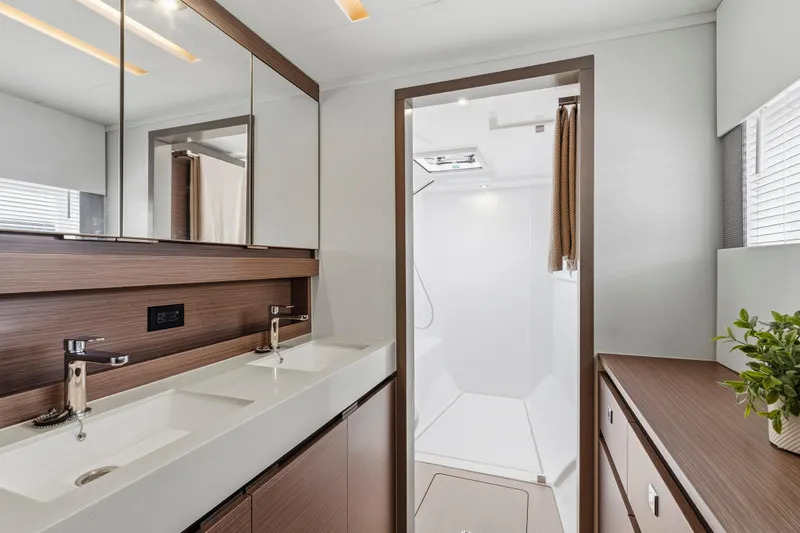 Closer To The Sun Yacht Photos Pics Luxurious bathroom interior of 2025 Leopard 53 Powercat yacht with dual sinks and modern design.