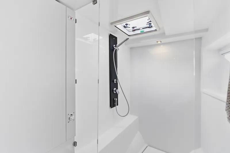 Closer To The Sun Yacht Photos Pics Modern shower area in 2025 Leopard 53 Powercat yacht, featuring sleek design and overhead hatch.