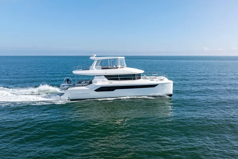 Closer To The Sun Yacht Photos Pics 2025 Leopard 53 Powercat cruising on open sea under clear blue sky.