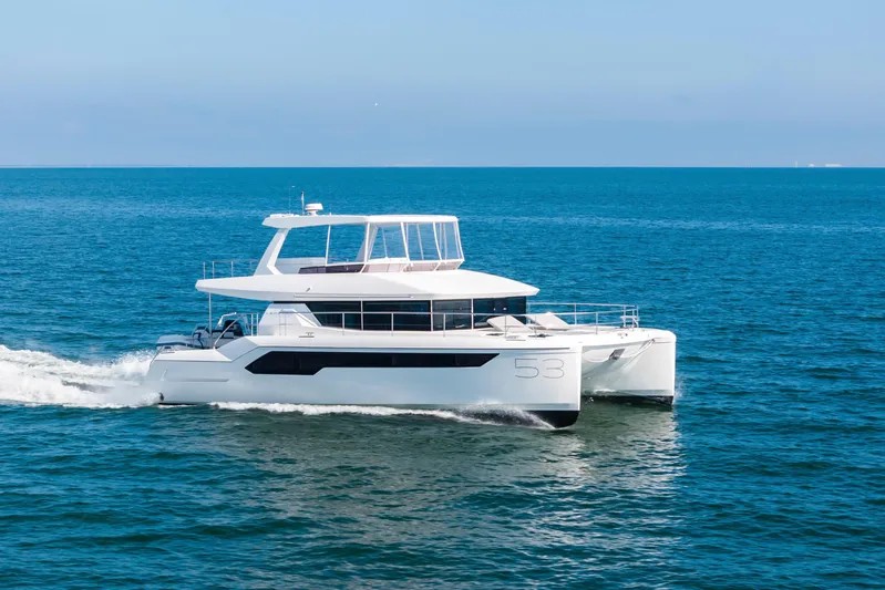 Closer To The Sun Yacht Photos Pics 2025 Leopard 53 Powercat cruising on open sea under clear blue sky.