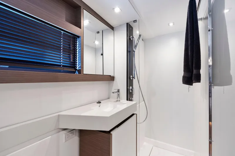 Closer To The Sun Yacht Photos Pics Modern bathroom interior on 2025 Leopard 53 Powercat yacht, featuring sleek design and fixtures.