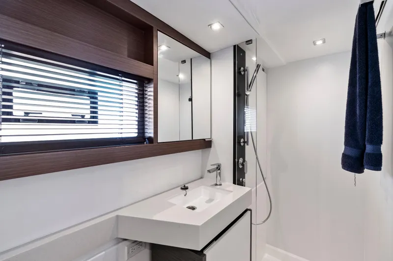 Closer To The Sun Yacht Photos Pics Modern bathroom interior on 2025 Leopard 53 Powercat yacht, featuring sleek design and fixtures.
