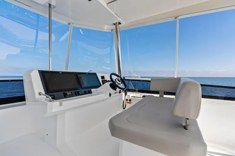 Closer To The Sun Yacht Photos Pics 2025 Leopard 53 Powercat helm with modern controls and ocean view.