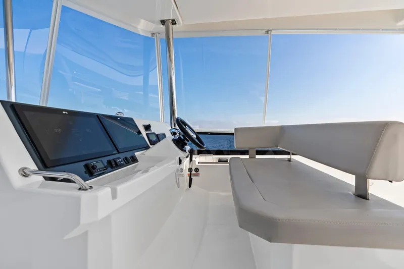 Closer To The Sun Yacht Photos Pics Interior view of 2025 Leopard 53 Powercat helm with modern controls and seating.