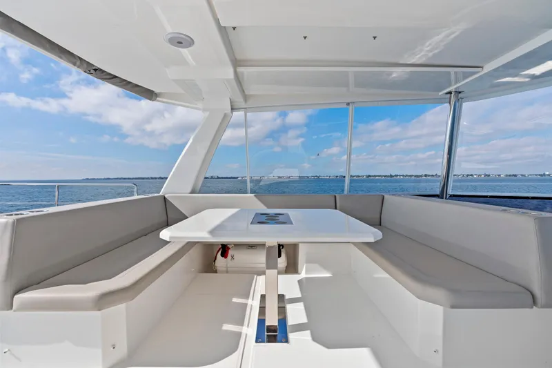 Closer To The Sun Yacht Photos Pics Spacious seating area on 2025 Leopard 53 Powercat yacht with ocean view.