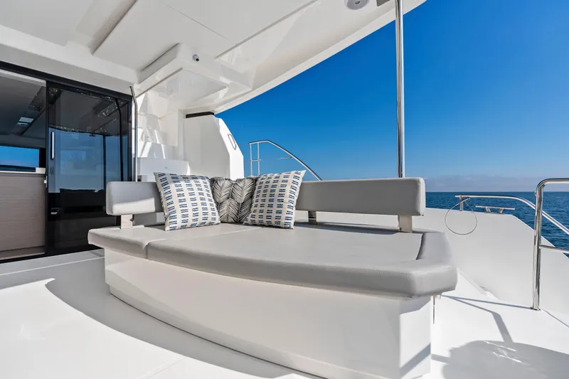 Closer To The Sun Yacht Photos Pics Luxurious seating area on 2025 Leopard 53 Powercat yacht with ocean view.