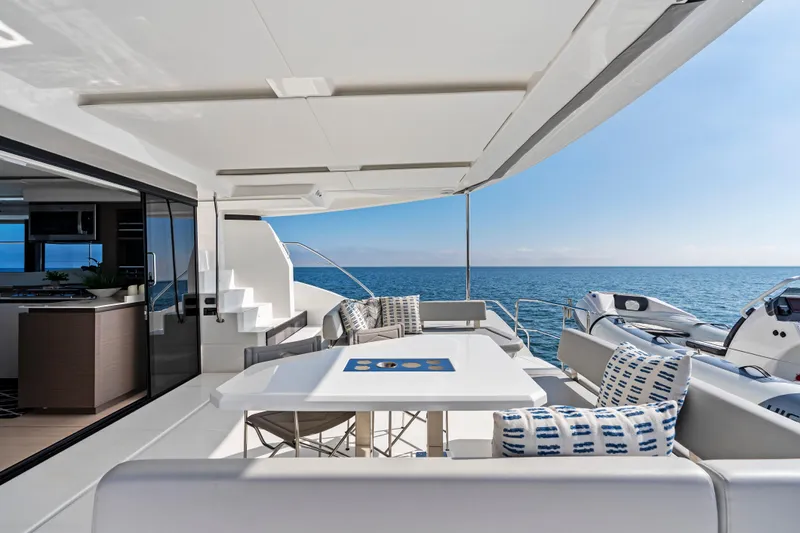 Closer To The Sun Yacht Photos Pics Luxurious 2025 Leopard 53 Powercat yacht deck with ocean view and modern seating.