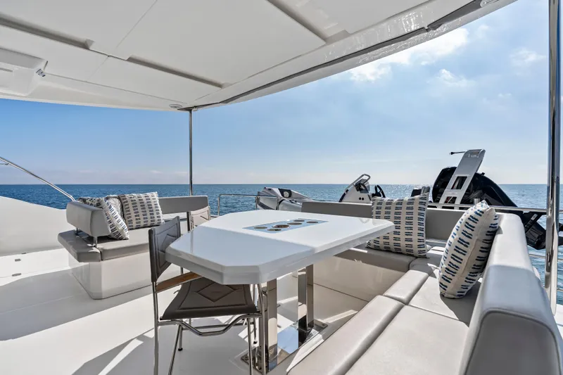 Closer To The Sun Yacht Photos Pics Luxurious 2025 Leopard 53 Powercat yacht deck with seating and ocean view.