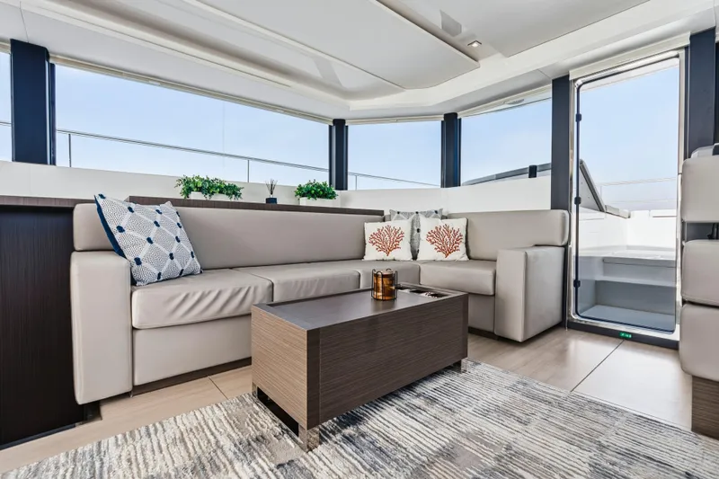 Closer To The Sun Yacht Photos Pics Luxurious interior of 2025 Leopard 53 Powercat yacht with modern seating and decor.