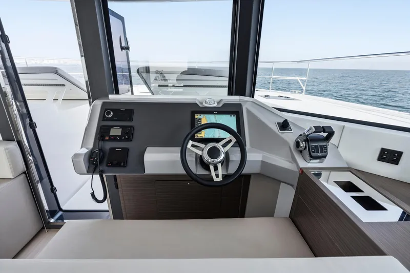 Closer To The Sun Yacht Photos Pics Helm of 2025 Leopard 53 Powercat with modern navigation controls and ocean view.