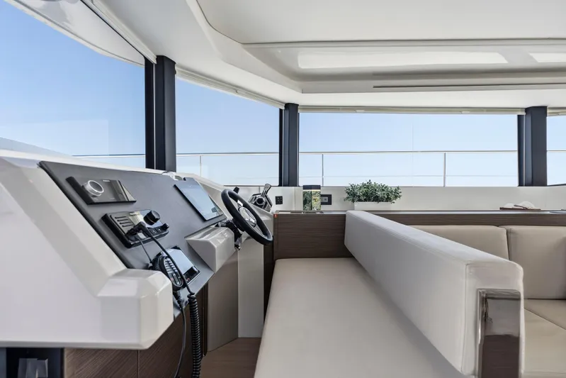 Closer To The Sun Yacht Photos Pics Interior of 2025 Leopard 53 Powercat yacht, featuring modern helm and seating area.