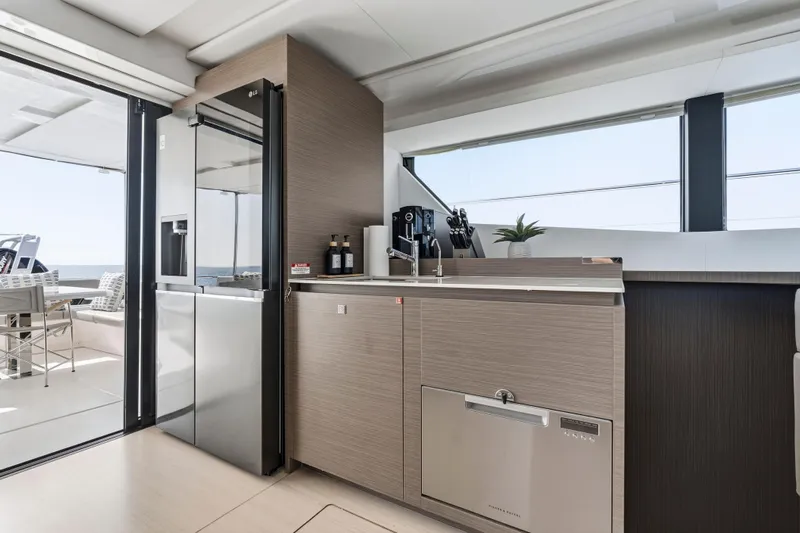 Closer To The Sun Yacht Photos Pics Modern kitchen interior on 2025 Leopard 53 Powercat yacht, featuring sleek appliances and ocean view.