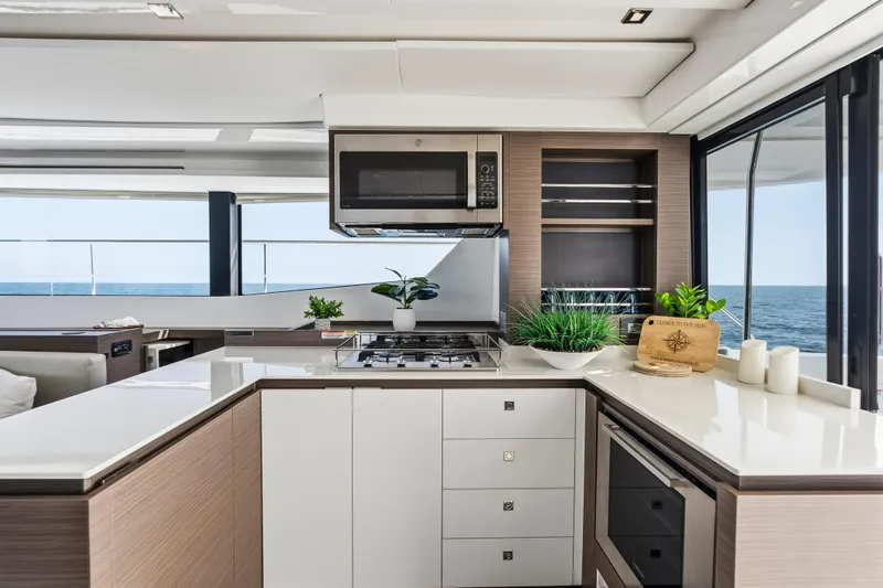 Closer To The Sun Yacht Photos Pics Modern kitchen interior on 2025 Leopard 53 Powercat yacht with ocean view.