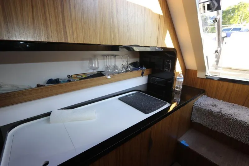  Yacht Photos Pics Modern kitchen area in 2018 Canados Gladiator 428 yacht with wooden cabinetry.