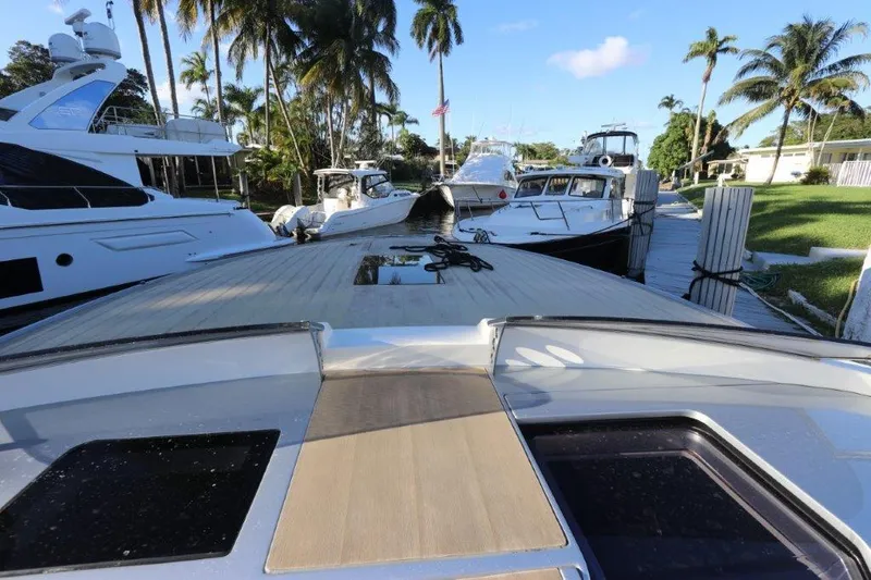  Yacht Photos Pics 2018 Canados Gladiator 428 docked with other luxury yachts, surrounded by palm trees.