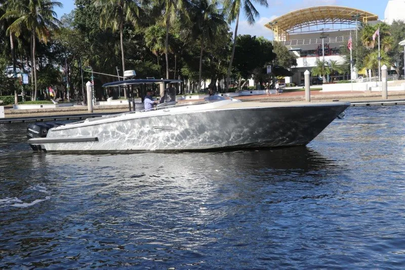  Yacht Photos Pics 2018 Canados Gladiator 428 boat cruising on a sunny day near a waterfront park.