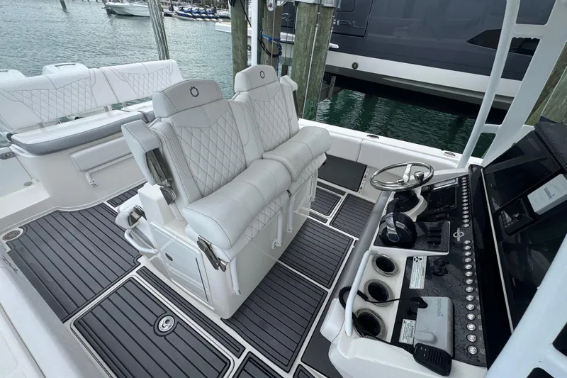  Yacht Photos Pics 2018 Fountain 34 Center Console boat interior with white seating and modern dashboard controls.