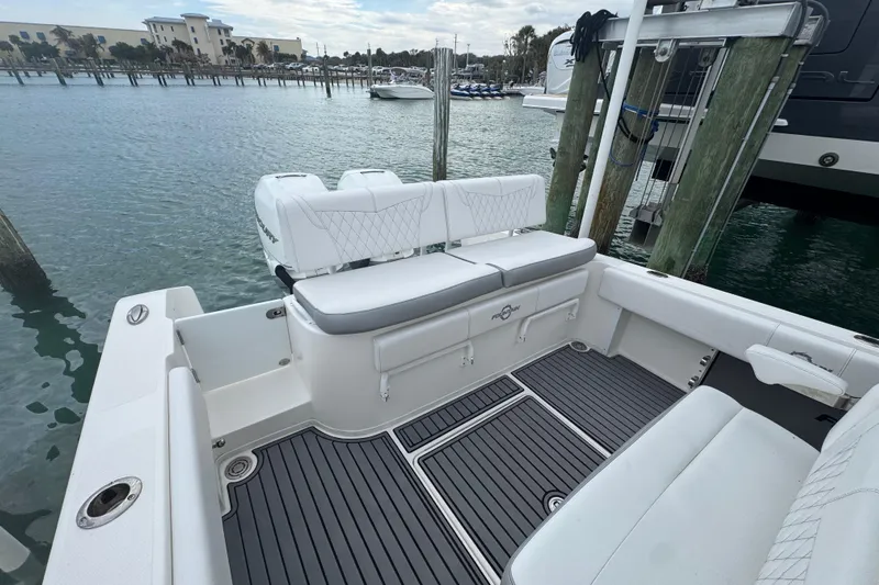  Yacht Photos Pics 2018 Fountain 34 Center Console boat docked, featuring spacious seating and sleek design.
