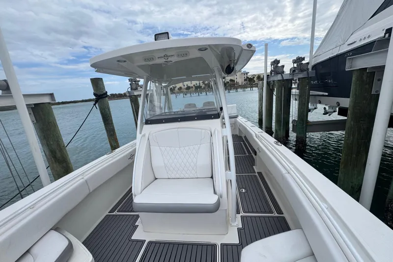  Yacht Photos Pics 2018 Fountain 34 Center Console boat docked, featuring sleek design and spacious seating.