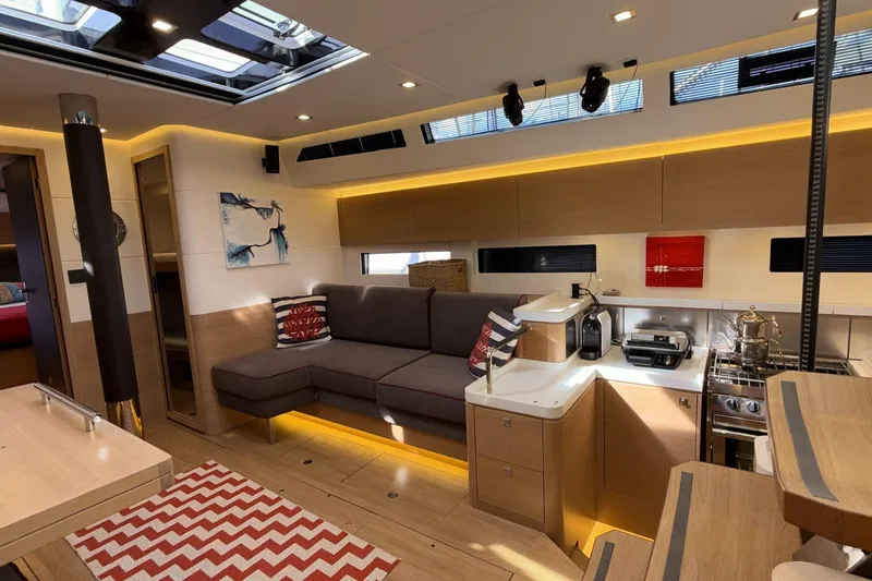  Yacht Photos Pics Luxurious interior of 2019 Amel 50 yacht with modern kitchen and cozy seating area.