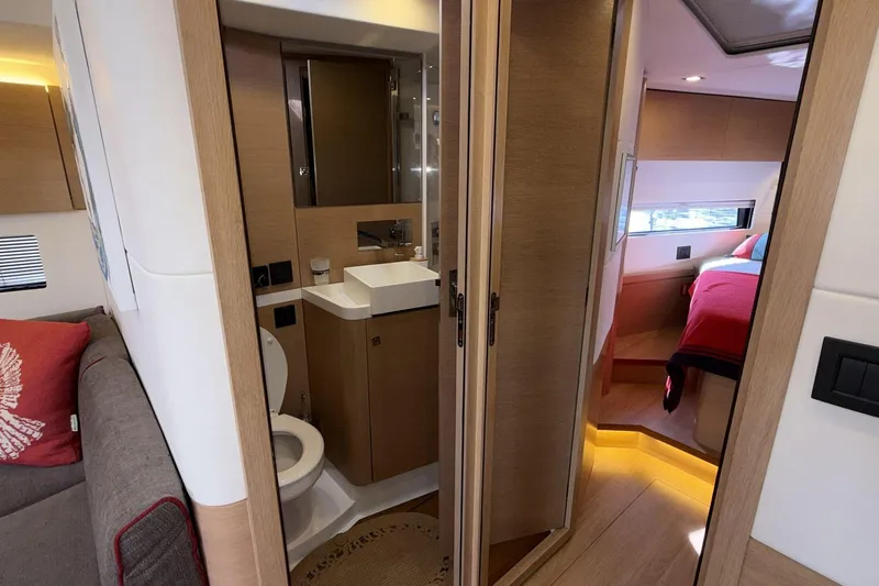  Yacht Photos Pics Luxurious interior of 2019 Amel 50 yacht featuring bathroom and cozy bedroom.