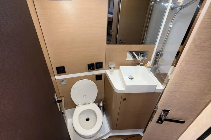  Yacht Photos Pics Compact bathroom in 2019 Amel 50 yacht with toilet, sink, and shower.
