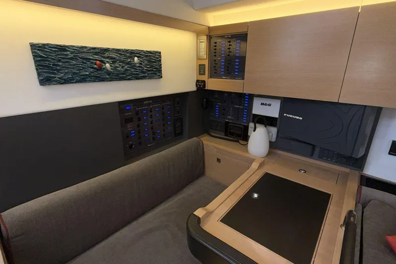  Yacht Photos Pics Modern interior of 2019 Amel 50 yacht with control panels and seating area.