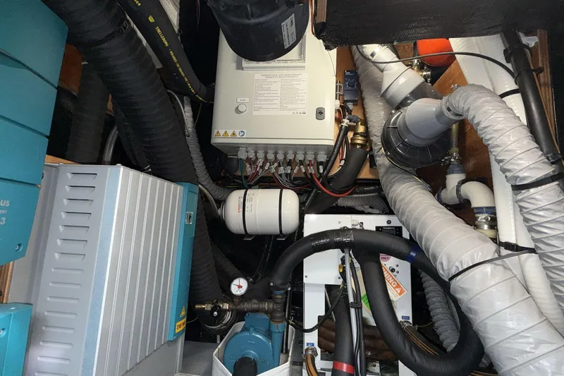  Yacht Photos Pics Engine room of a 2019 Amel 50 yacht with complex mechanical systems.