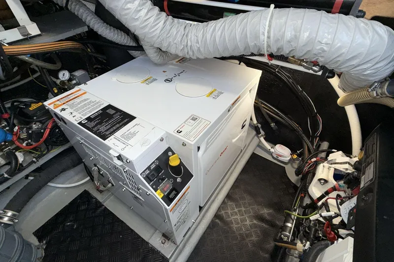  Yacht Photos Pics Engine room of a 2019 Amel 50 yacht with generator and wiring.